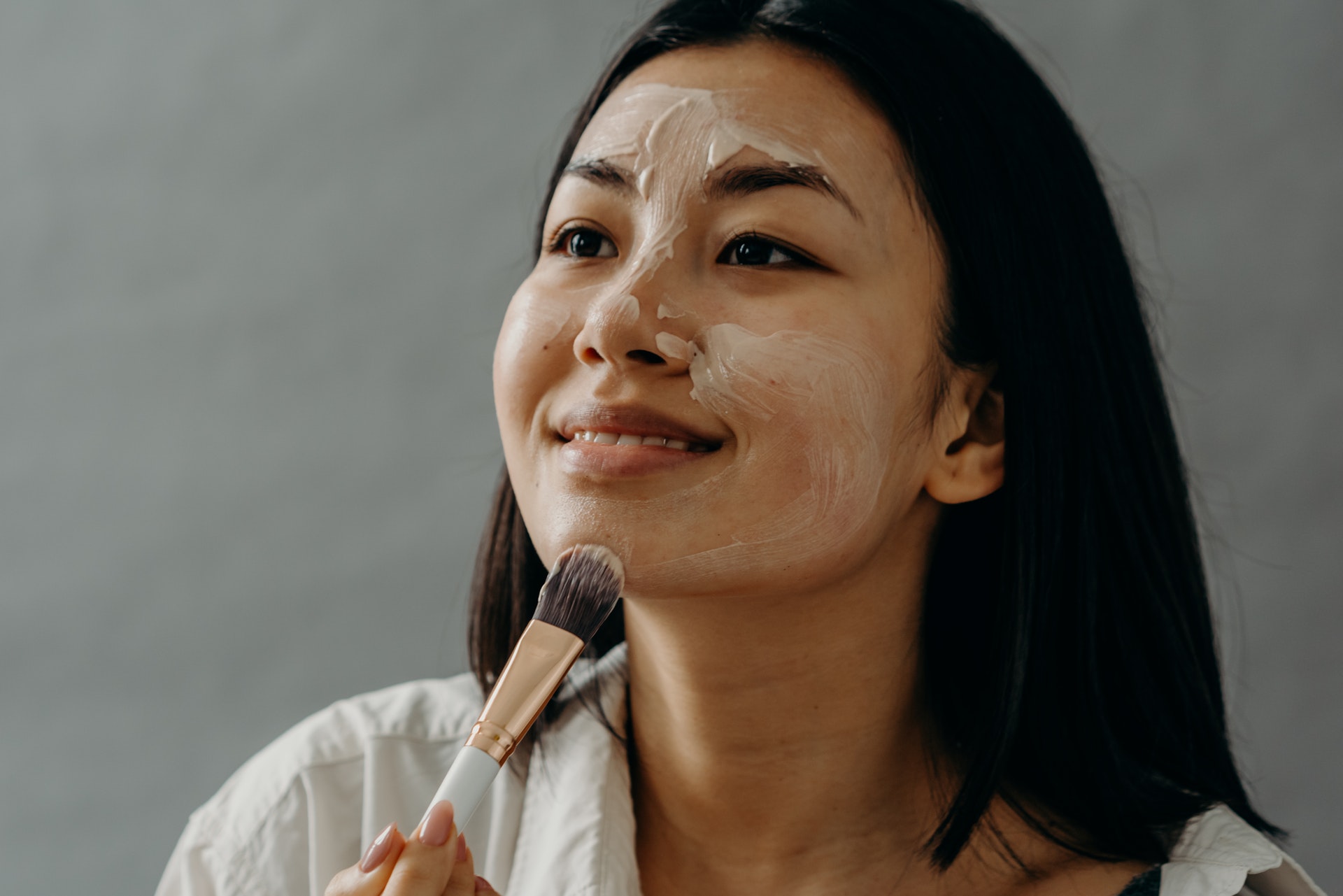 Woman applying one of diy masks for dry skin